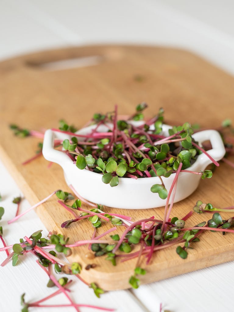 Crisp garden cress sprouts on a wooden board, perfect for health-focused culinary uses.